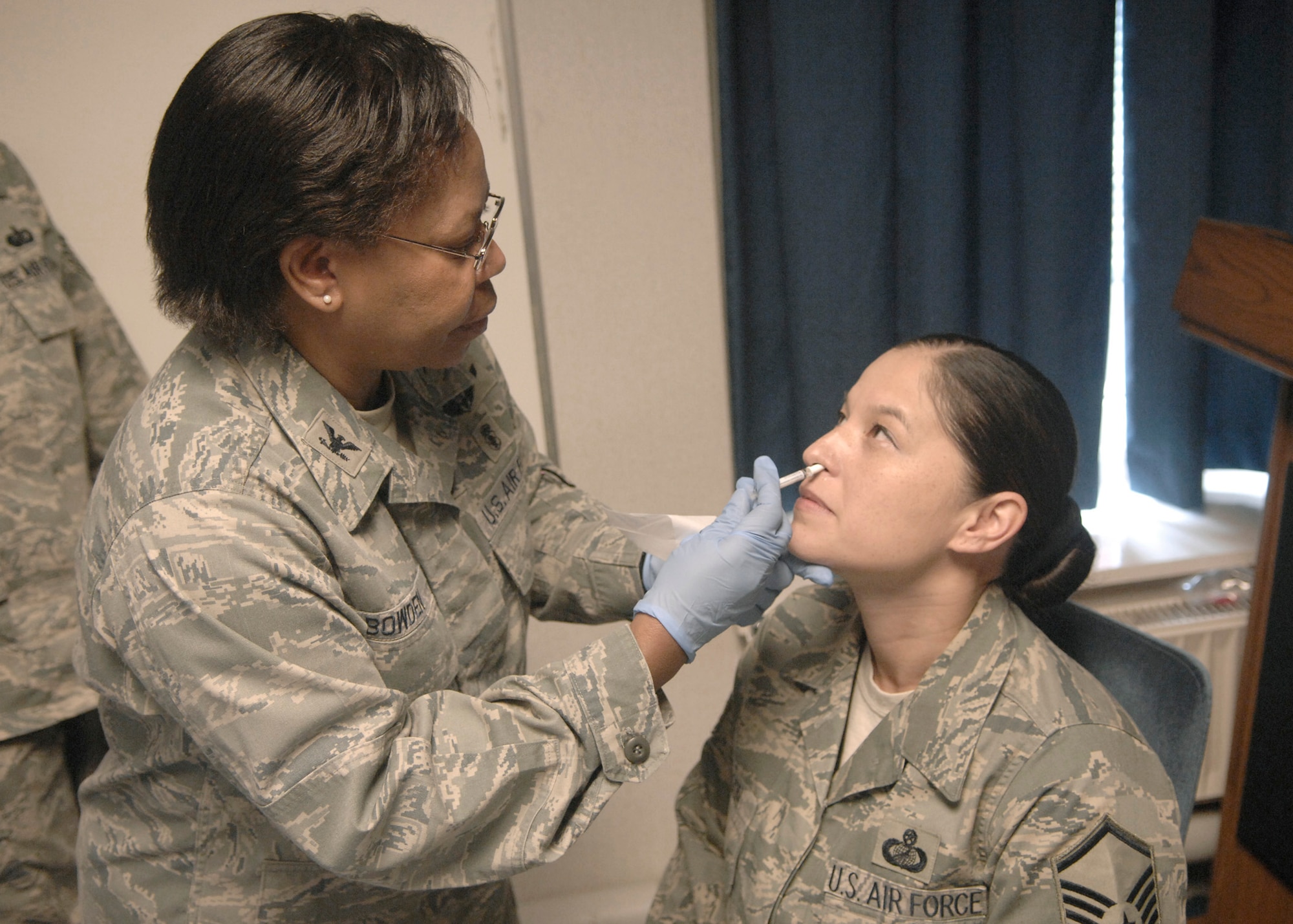 Col. Allison Bowden, 48th Medical Group chief nurse, administers FLUMIST to Master Sgt. Peggy Faison from the 100th Comptroller Squadron. The vaccination is part of the 48th MDG 2009-2010 Influenza Plan. Unit Deplotment Monitors can contact the Immunization Clinic to arrange a "shot line" for their units. (U.S. Air Force photo/Master Sgt. Charles Tubbs)