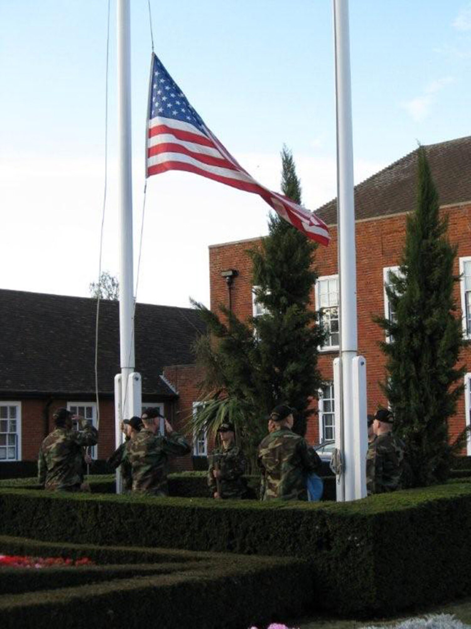 Airmen for the 100th Civil Engineer Squadron Fire Department perform a Retreat ceremony in front of the 100th Air Refueling Wing Headquarters Oct. 4, 2009. The ceremony was the official kick off of Fire Prevention Week. The flag is flown at half-staff in honor of the National Fallen Firefighters Memorial Service. (U.S. Air Force photo)
