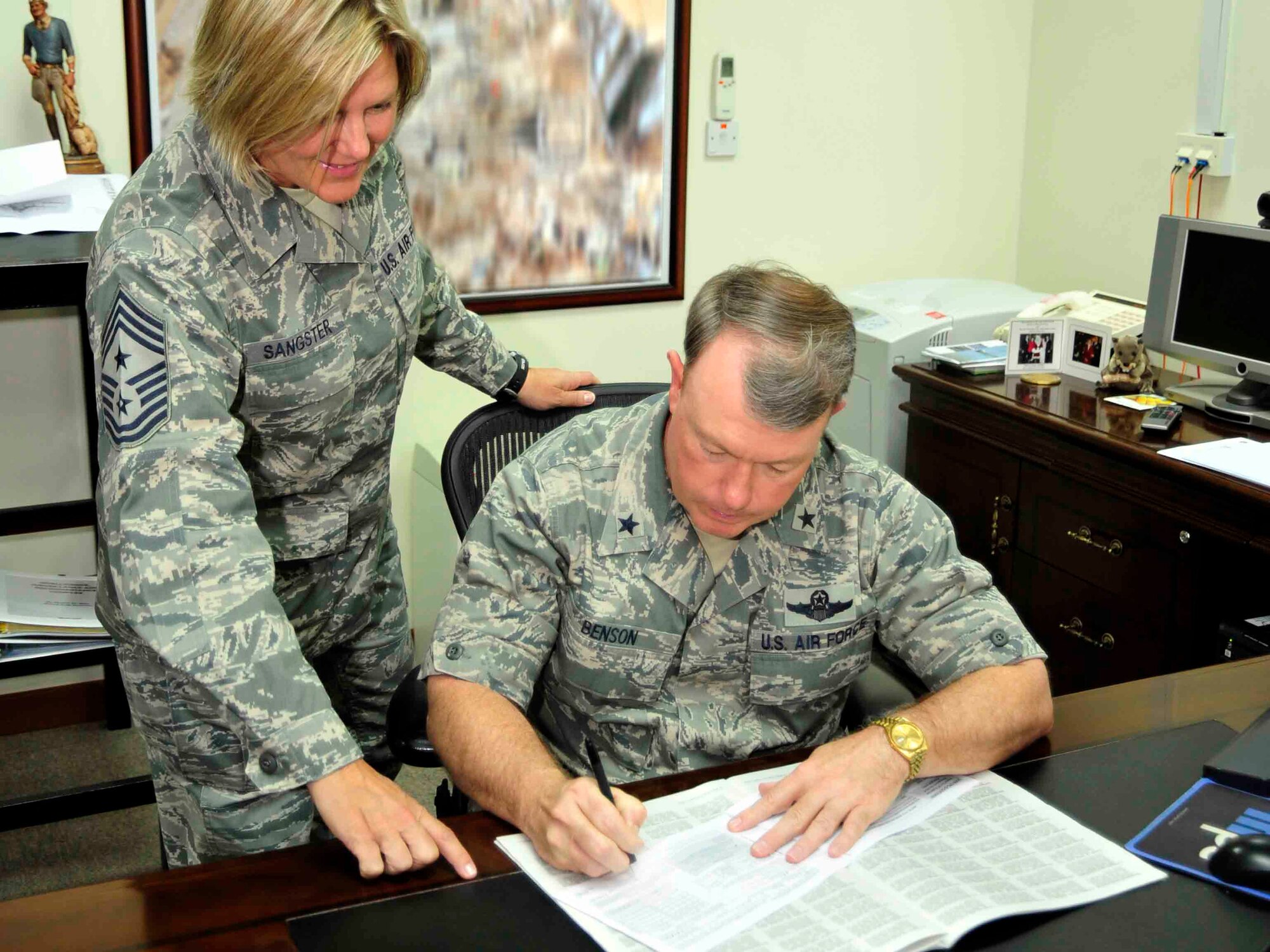 SOUTHWEST ASIA - Brig. Gen. Bryan Benson, 380th Air Expeditionary Wing commander, signs his donation form for the Combined Federal Campaign-Overseas Oct. 3, 2009. General Benson led the way as the first to donate from the 380th AEW. (U.S. Air Force photo/Tech. Sgt. Charles Larkin Sr)