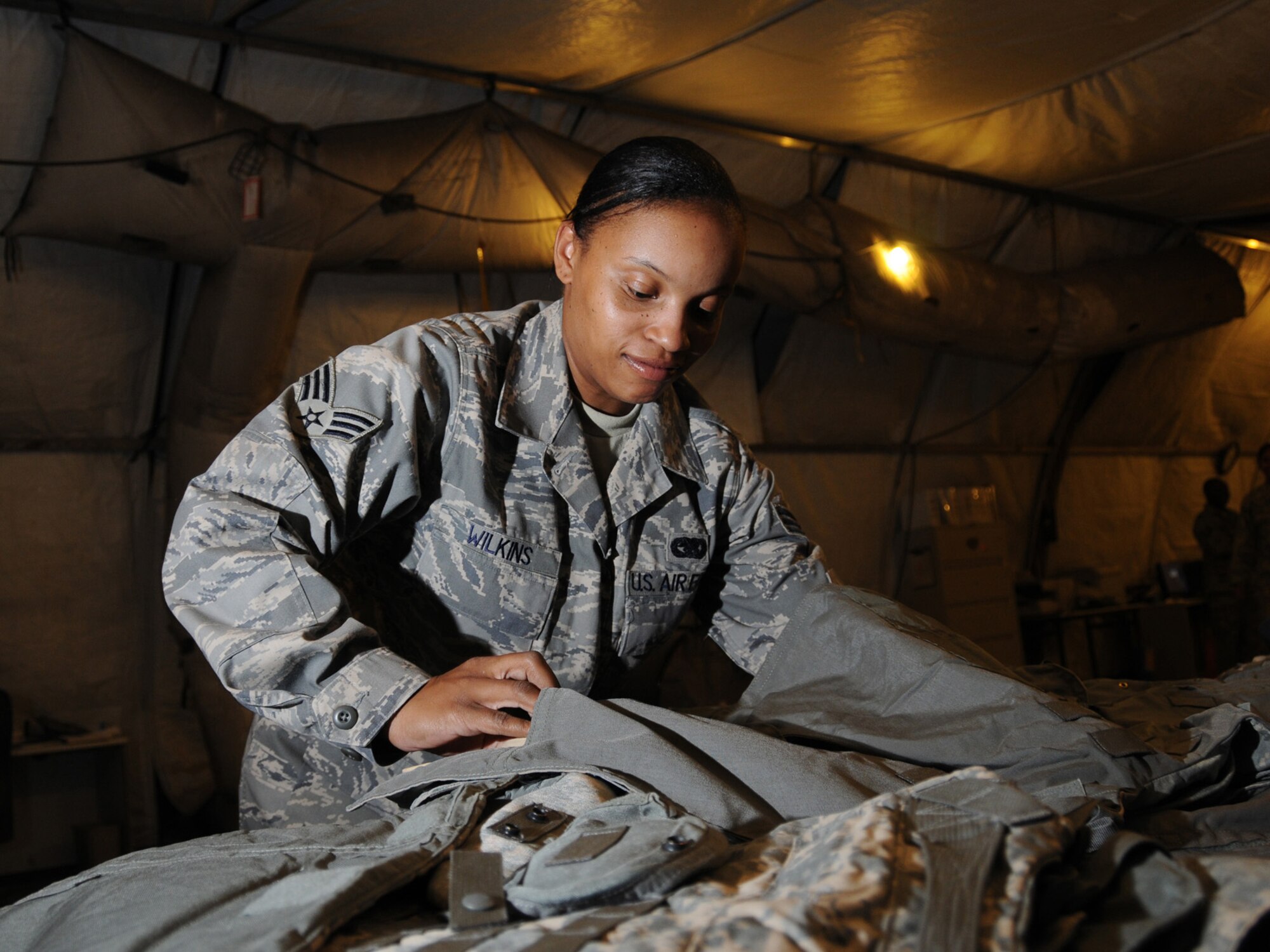 Senior Airman Lenetria Wilkins, 379th Expeditionary Logistics Readiness Squadron readiness technician assembles outer tactical vests at the expeditionary theater distribution center warehouse, Oct. 1.The ETDC warehouse stores mobility equipment to be issued to transient personnel as the deploy to forward bases. Airman Wilkins is deployed from Little Rock Air Force Base, Ark. in support of Operations Iraqi and Enduring Freedom. (U.S. Air Force Photo/Tech. Sgt. Jason W. Edwards)