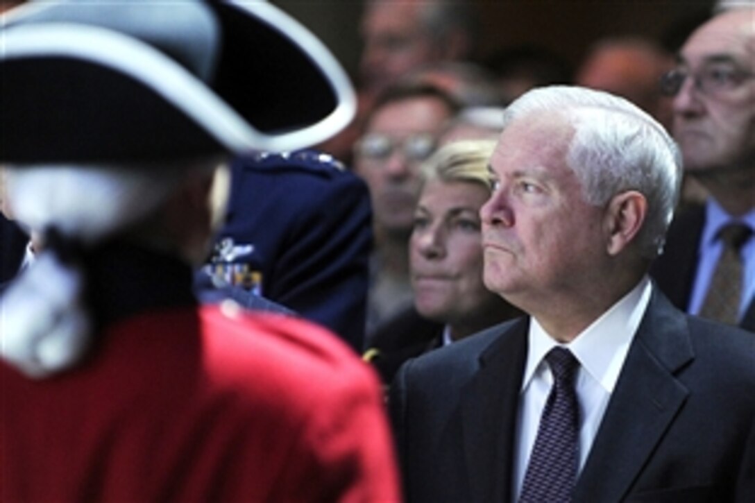 Defense Secretary Robert M. Gates watches on as the colors are presented during the opening ceremonies of the Association of the United States Army meeting and exposition in Washington, D.C.,  Oct. 5, 2009.