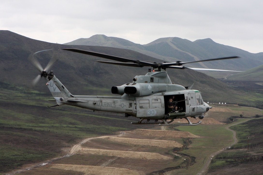 A UH-1Y Huey from Marine Light Attack Helicopter Squadron 267 cruises over Marine Corps Base Camp Pendleton, Calif. Oct. 20. The Huey bears the squadron's distinctive Ace of Spades or "death card."