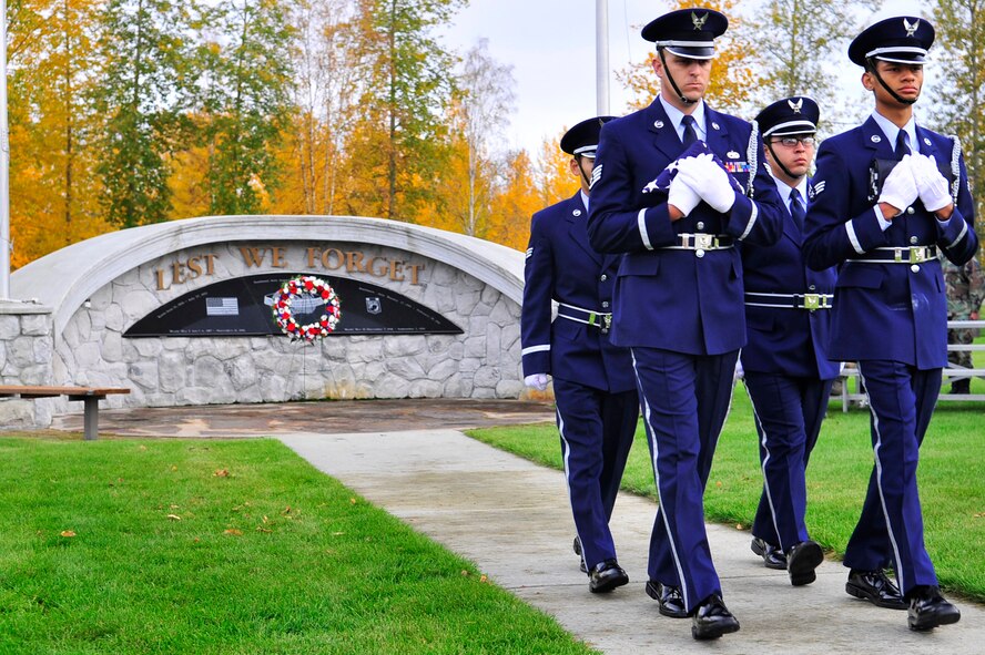 Airmen from the Honor Guard secure the flags during the Prisoners of War-Missing in Action Ceremony Sept. 18 at Eielson Air Force, Base, Alaska. The POW-MIA ceremony pays tribute to those who were captured or have gone missing during war. Since World War I, more than 296,800 Americans have been classified as POW-MIA. (U.S. Air Force photo/Staff Sgt. Christopher Boitz)