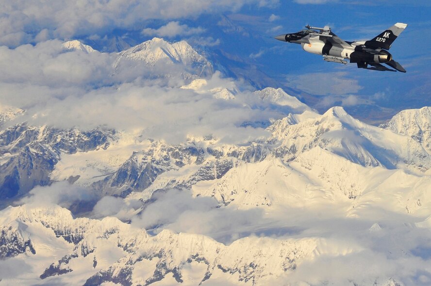An F-16 Aggressor soars above snow capped mountains in the Joint Pacific Alaska Range Complex Sept. 14 near Eielson Air Force, Base, Alaska. The F-16 is assigned to the 18th Aggressor Squadron, who are responsible for training and preparing joint and allied aircrews for comabat missions. (U.S. Air Force photo/Staff Sgt. Christopher Boitz)