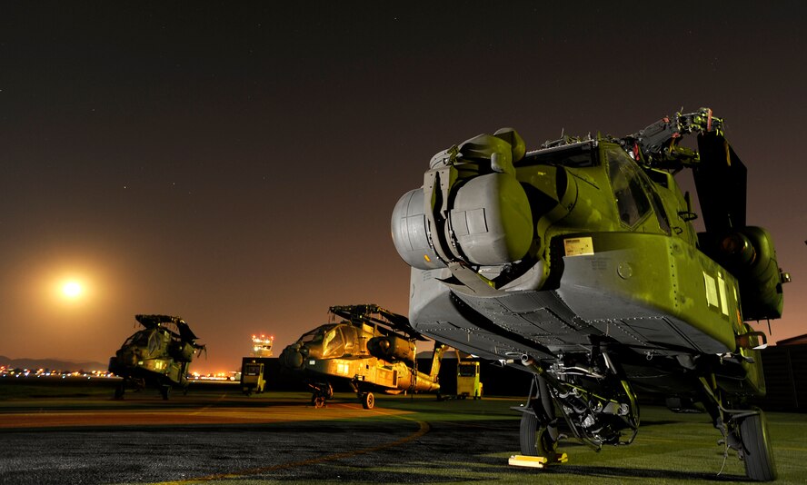 Three AH-64D Apache Longbows sit on the Osan Air Base, Republic of Korea, flightline Sept 9. These helicopters are the first of 24 the Army is swapping for the newer block II model over the next four months.  (U.S. Air Force photo/Staff Sgt. Brian Ferguson)