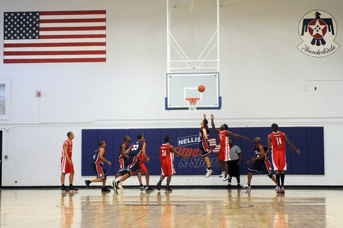NELLIS AIR FORCE BASE, Nev.--  J. Hall, a member of the Nellis Men's Basketball Team, drives the lane for a lay-up against the Marine Corps Air Station, varsity basketball team from Yuma, Ariz., during a joint service varsity basketball tournament held at the Nellis Fitness center, Oct. 3.  (U.S. Air Force photo by Tech. Sgt. Michael R. Holzworth)
