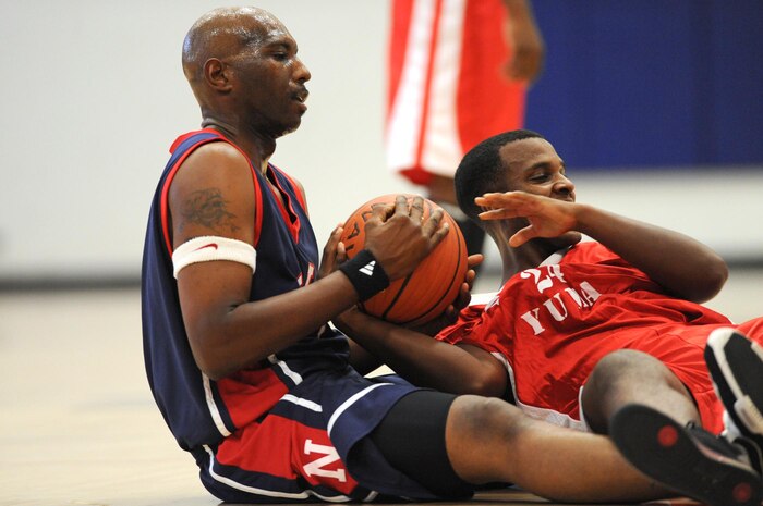 NELLIS AIR FORCE BASE, Nev.-- Darrell Works from Marine Corps Air Station, Yuma, Ariz., fights for a loose ball with Greg Moore, a member of Nellis Men's Basketball Team, during a joint service varsity basketball tournament held at the Nellis fitness center, Oct. 3.  (U.S. Air Force photo by Tech. Sgt. Michael R. Holzworth)