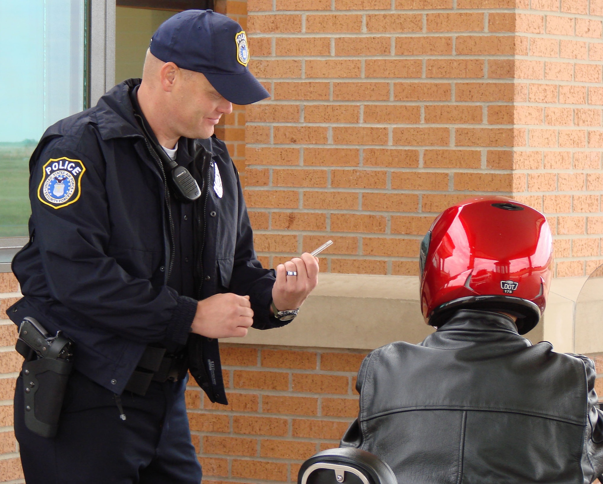 Corey Spradlin, a Department of the Air Force police officer, checks for identification at Vance’s main gate. Active duty security forces and Department of the Air Force police are once again manning the gates here, which has been a job for civilian contractors since 2002.