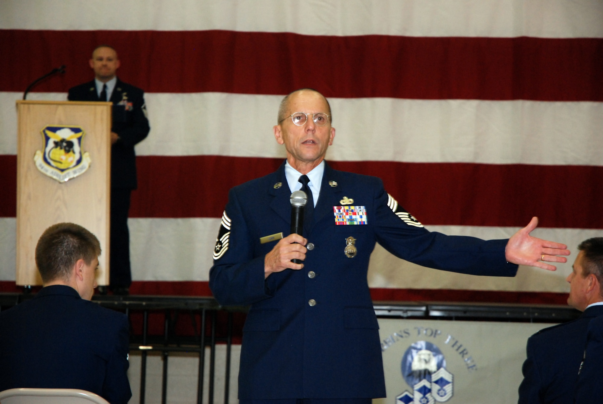 Chief Master Sgt. Jeffrey Cain, 22nd Air Force, offers words of encouragement during the Senior NCO Induction Ceremony Oct. 3 in Hangar 5. Col. Heath Nuckolls, 94th AW commander, presented each SNCO with a Certificate of Induction during the ceremony, which was sponsored by the Dobbins Top III group.

