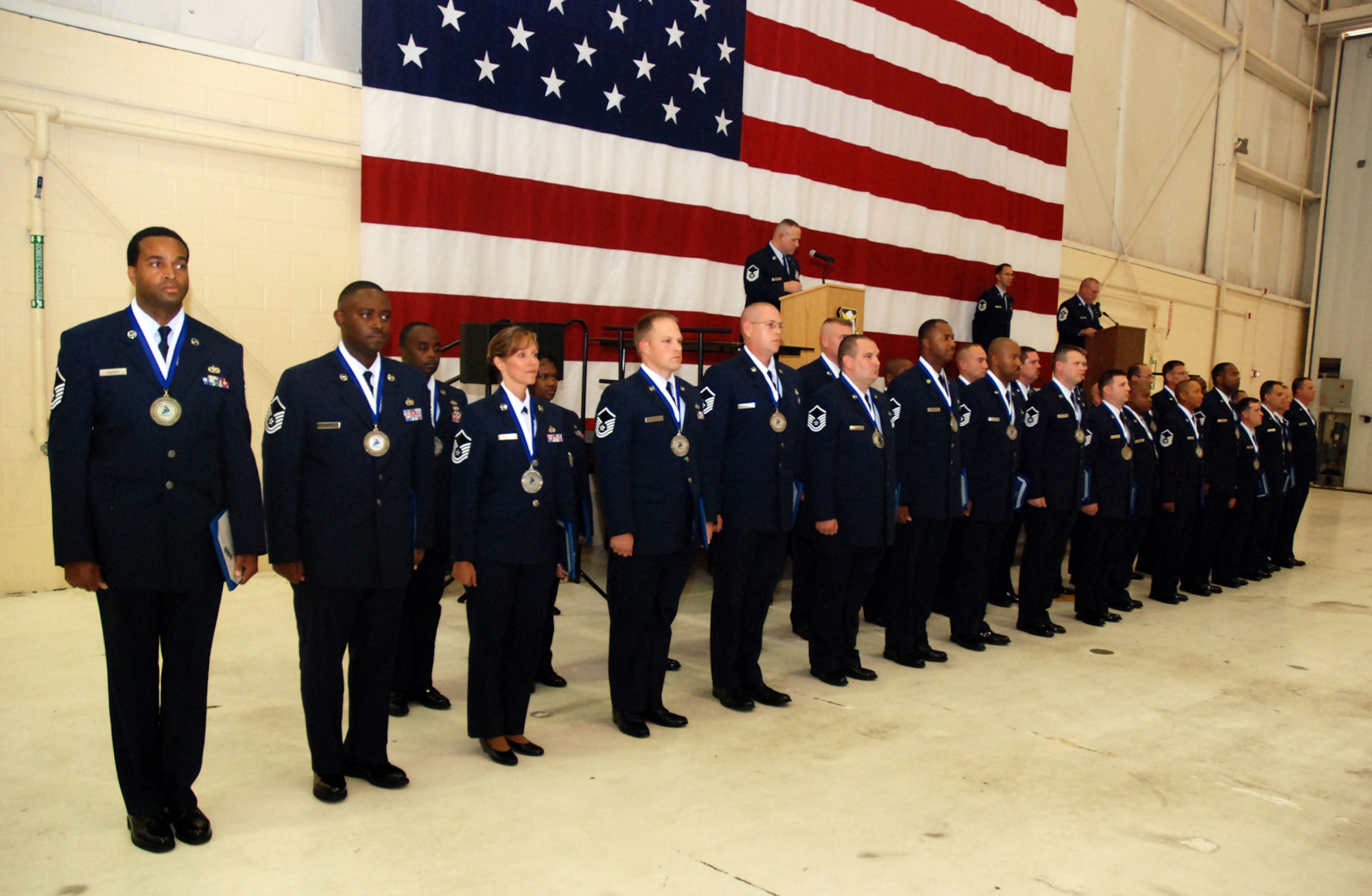 Newly promoted master sergeants stand at attention during the Senior NCO Induction Ceremony Oct. 3 in Hangar 5. Col. Heath Nuckolls, 94th AW commander, presented each SNCO with a Certificate of Induction during the ceremony, which was sponsored by the Dobbins Top III group.

