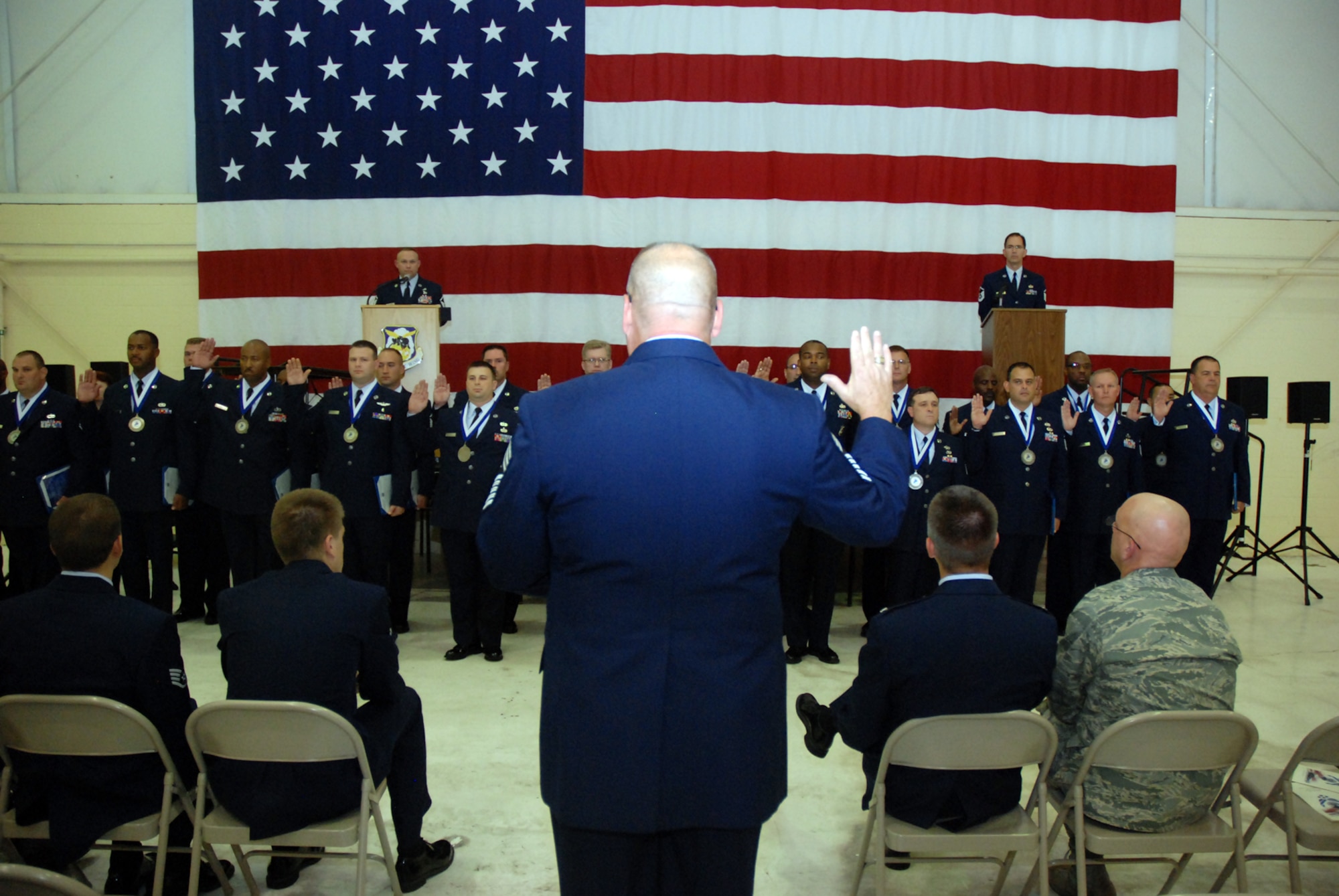 Chief Master Sgt. John Anderson, 94th Airlift Wing command chief, inducts 30 newly promoted master sergeants at the Senior NCO Induction Ceremony Oct. 3 in Hangar 5. Col. Heath Nuckolls, 94th AW commander, presented each SNCO with a Certificate of Induction during the ceremony, which was sponsored by the Dobbins Top III group.

"When an Air Force NCO is promoted to master sergeant, they take on more responsibility as more is expected of them," said Chief Anderson. "This ceremony was a formal way to recognize their new promotion and to reemphasize their responsibility to lead, guide and mentor Airmen.