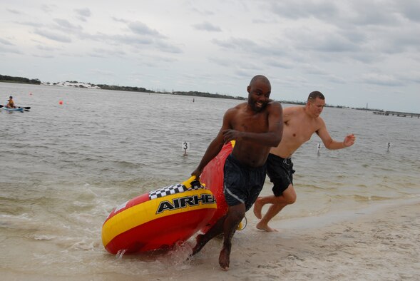 U.S. Air Force Staff Sgt. Briane Rock, 1st Special Operations Force Support Squadron (left), and 1st Lt. Andrew Burns, 413th Flight Test Squadron (right), race to the finish line in the inner tube relay race during the H2Olympics at Hurlburt Field, Fla., Oct. 2, 2009. (U.S. Air Force photo by Staff Sgt. Orly N. Tyrell) 
