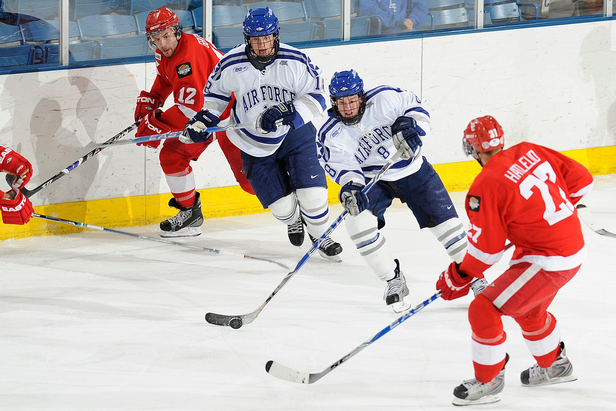 Air Force junior forward Scott Kozlak tries to outmaneuver Calgary defender Dustin Hatlelid during the Falcons-Dinos exhibition game at the Cadet Ice Arena Oct. 5, 2009. The Falcons won the match on two goals by junior forward Jacques Lamoureux. Kozlak is a native of Duluth, Minn. (U.S. Air Force photo/Bill Evans)