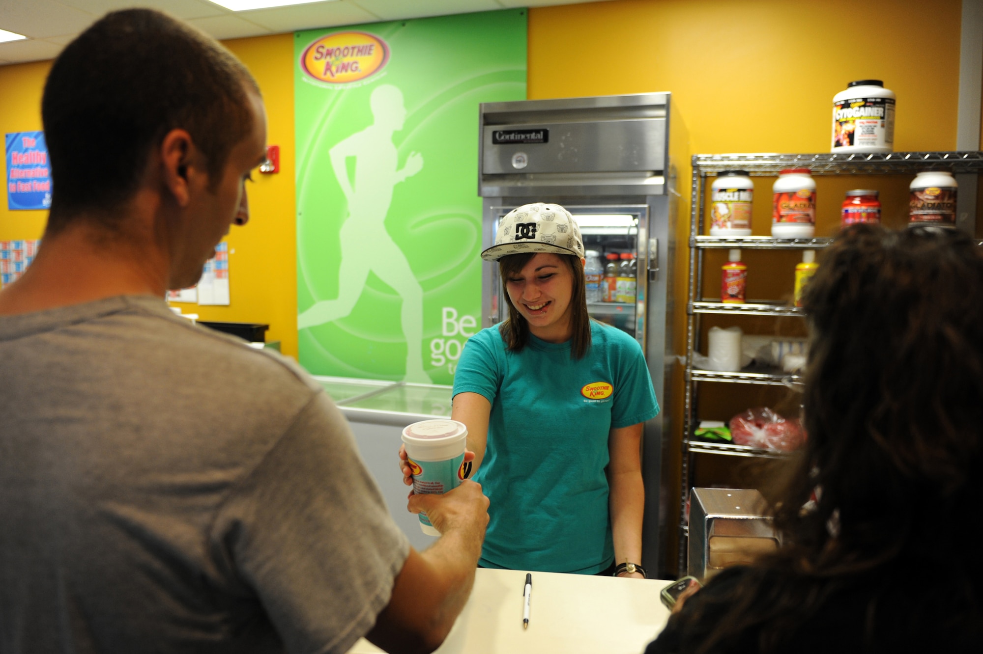 Alayna Puckett, Smoothie King technician, serves a fresh drink to a customer Sept. 15 at the Sports and Fitness Center on base. This is the sixth consecutive year that the fitness center staff has received a 5-star rating due to their constant vigilance and attention to detail while improving the facility to meet individual needs. (U.S. Air Force photo by Senior Airman Ethan Morgan)