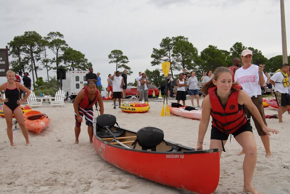 U.S. Air Force Tech. Sgt. Noel Cabell (back) and Senior Airman Danielle Williams (front), 1st Special Operations Component Maintenance Squadron, wait for the sound of the horn starting the second leg of the canoe relay race during the H2Olympics at Hurlburt Field, Fla., Oct. 2, 2009.(U.S. Air Force photo by Staff Sgt. Orly N. Tyrell) 
