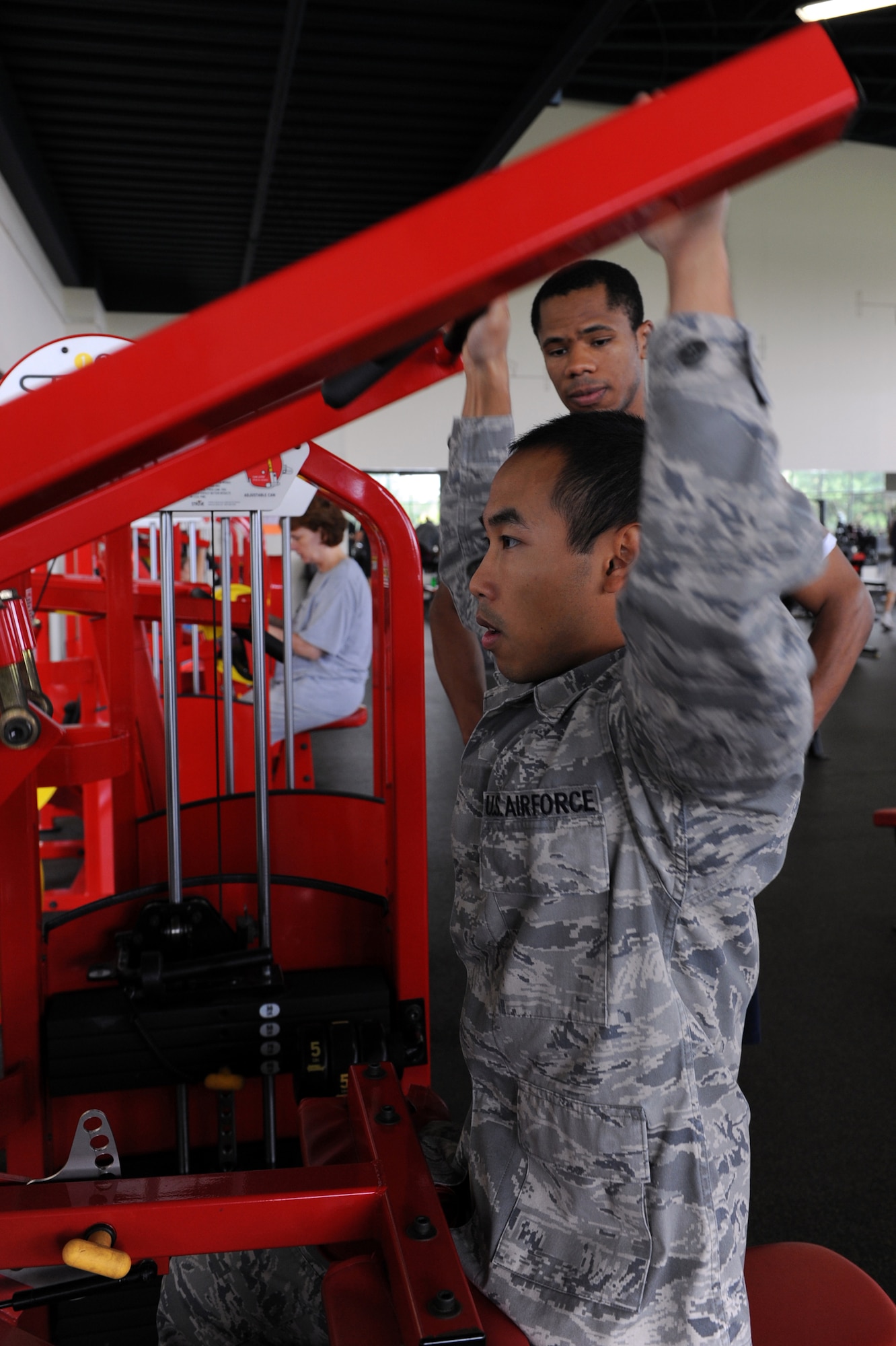 Senior Airman Rong Meak, 19th Force Support Squadron fitness specialist, shows Senior Airman Jose Timana, 19th FSS fitness specialist, the proper technique to use a weight machine Sept. 15 at the base Sports and Fitness Center. This is the sixth consecutive year that the fitness center staff has received a 5-star rating due to their constant vigilance and attention to detail while improving the facility to meet individual needs. (U.S. Air Force photo by Senior Airman Ethan Morgan)