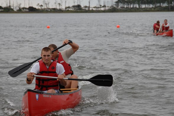 U.S. Air Force Airman 1st Class Allen Buning (front) and Staff Sgt. Michael McQuiggin (back), 1st Special Operations Security Forces Squadron, increase their lead over their competitors in the canoe relay race during the H2Olympics at Hurlburt Field, Fla., Oct. 2, 2009. (U. S. Air Force photo by Staff Sgt. Orly N. Tyrell) 
