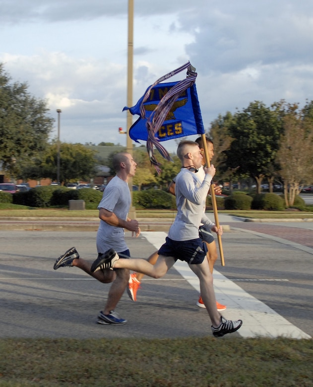 Members of the 437th Civil Engineer Squadron cross the finish line after running in the Commander's Fitness Challenge 5K run here Oct. 2. Units from around the base gathered in formations to run in the event. (U.S. Air Force photo/Staff Sgt. Daniel Bowles)