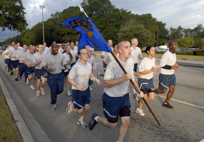 Members of the 437th Communications Squadron make a loud finish as they approach the end of the Commander's Fitness Challenge 5K run on Hill Boulevard Oct. 2. The run began after a welcome from 437th Airlift Wing Commander Col. John Wood and ended with the 437 CS named as the unit with the most spirit by 437 AW Vice Commander Col. Don Shaffer. (U.S. Air Force photo/Staff Sgt. Daniel Bowles)