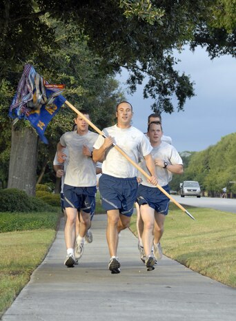 Members of the 14th Airlift Squadron dash toward the finish line in the home stretch of the Commander's Fitness Challenge 5K run here Oct. 2. A Commander's Fitness Challenge is held every other month to promote fitness and teamwork for Charleston AFB Airmen. (U.S. Air Force photo/Staff Sgt. Daniel Bowles)