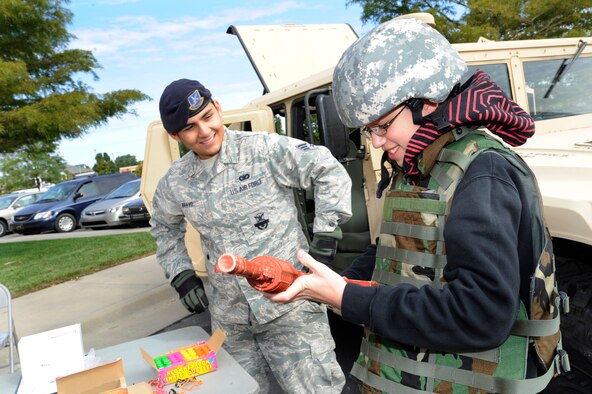 Senior Airman Robert Bravo, 22nd Security Forces Squadron, shows Jake Ellen, 13, a replica of an M-4 rifle, Oct. 3, 2009, during the 3rd Annual Law Enforcement Expo in Wichita, Kan.  Security forces Airmen, from McConnell Air Force Base, Kan., joined the Sedgwick County Sherriff’s Office, Wichita Police Department and other law enforcement agencies to educate citizens on crime prevention services. The Airmen showcased military security response vehicles, body armor and security training tactics to support National Crime Prevention Month in October. (U.S. Air Force photo/Staff Sgt. Jamie Train) 