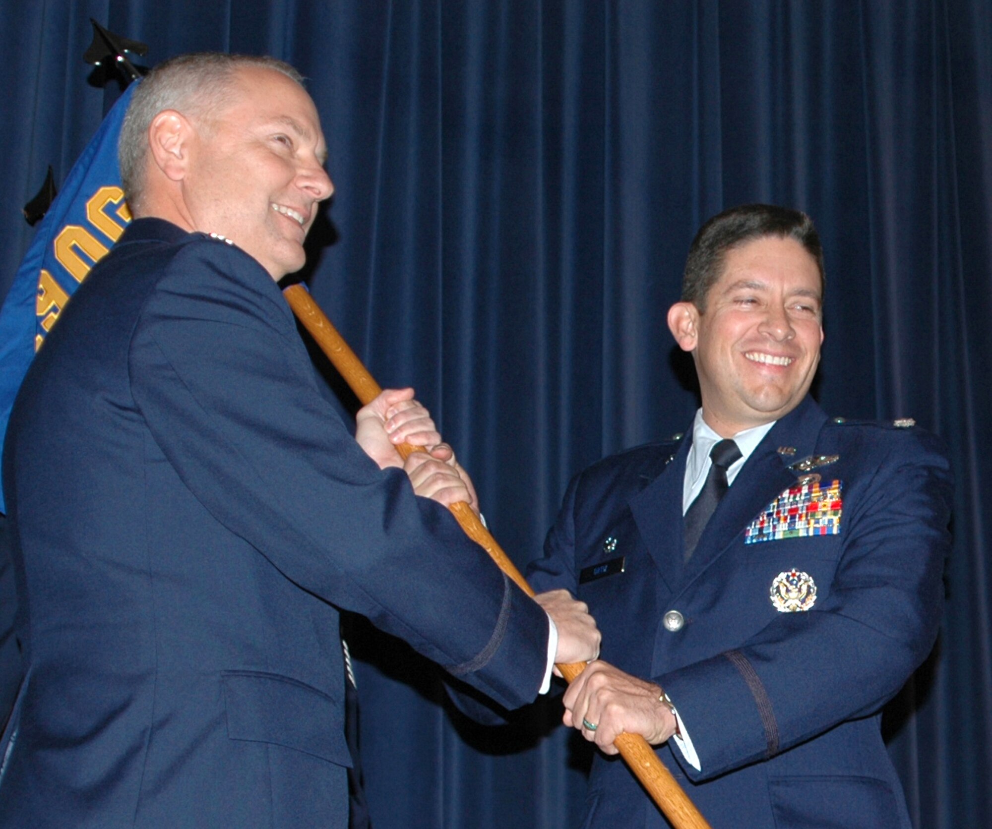 Lt. Col. Carlos Ortiz (right), 52nd Airlift Squadron commander, accepts the squadron guidon from Col. David Kasberg during an activation and assumption of command ceremony Oct. 3, 2009, at Peterson Air Force Base, Colo. The 52nd AS is active associate C-130 unit that will work with reservists in the Air Force Reserve's 302nd Airlift Wing at Peterson. Colonel Kasberg commands the 19th Operations Group at Little Rock AFB, Ark., which oversees the 52nd AS. (U.S Air Force photo/Tech. Sgt. Daniel Butterfield)
