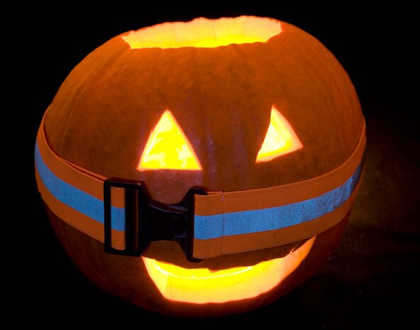 Freddy, 1st Fighter Wing Public Affairs' jack-o-lantern, dons a reflective belt in preparation for a safe Halloween. (U.S. Air Force photo/Staff Sgt. Barry Loo)