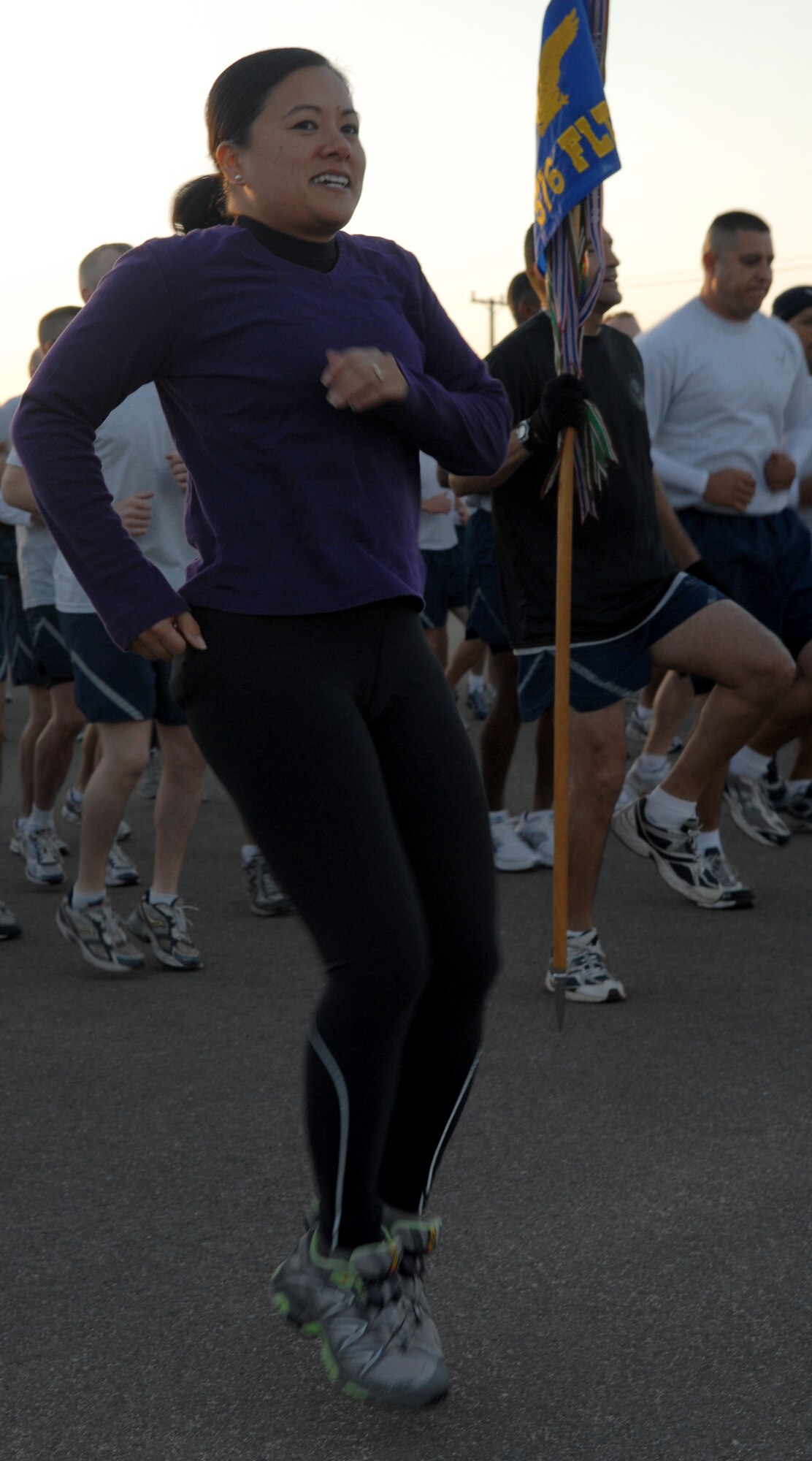 VANDENBERG AIR FORCE BASE, Calif. -- Jogging in place, Lt. Col. Maria Struck, 30th Operations Support Squadron commander, warms up before the September Fit-to-Fight run. Septembers run was unique because participants wore pink and purple shirts in support of Breast Cancer Awareness and Domestic Violence Awareness months. (U.S. Air Force photo/ Senior Airman Antionette Lyons)