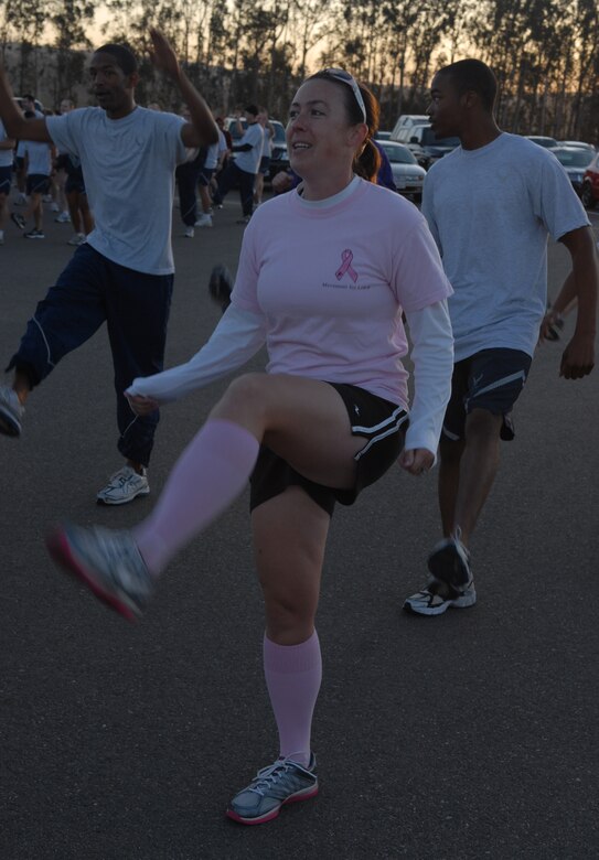VANDENBERG AIR FORCE BASE, Calif. -- Warming up with leg lifts, 1st Lt. Sarah Goyen, a 2nd Rang Operations Squadron senior range operator, stretches before the start of the September Fit-to-Fight run. Septembers run was unique because participants wore pink and purple shirts to recognize Breast Cancer and Domestic Violence Awareness months. (U.S. Air Force photo/ Senior Airman Antionette Lyons)