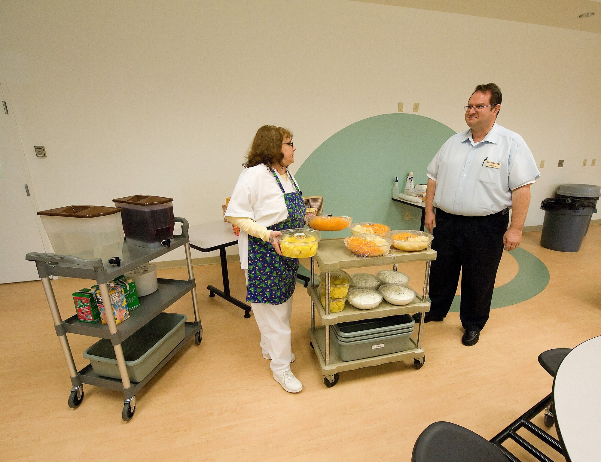 (Left to right) Terri Hutchinson, 436th Force Support Squadron Youth Center cook, prepares the snacks for the children at the Youth Center with Steve James, Youth Behavior consultant.  Ms. Hutchinson performed the Heimlich maneuver on Mr. James Sept. 9, when he choked on a carrot. (U.S. Air Force photo/Jason Minto)