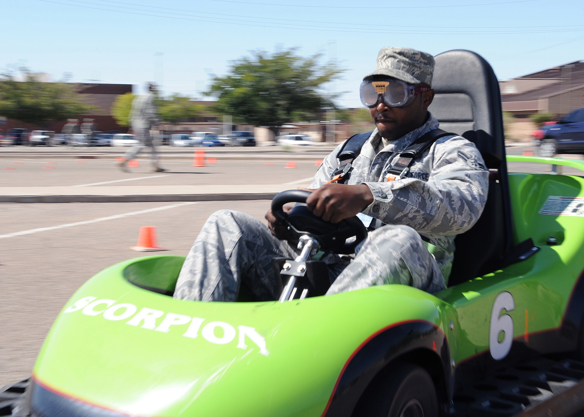 HOLLOMAN AIR FORCE BASE, N.M. -- Airman 1st Class Keith Rivers, 49th Communications Squadron, drives on an obstacle course while wearing the "drunken vision" goggles during Safety Day here Sept. 28. About 350 volunteers took part in a one-hour course called "The Danger of Texting While Driving" and "The Danger of Driving While Impaired." These special go-cart-sized cars were rigged to simulate reduced capability so Airmen could experience this without really drinking or texting while driving. (U.S. Air Force photo by Senior Airman John D. Strong II)   
