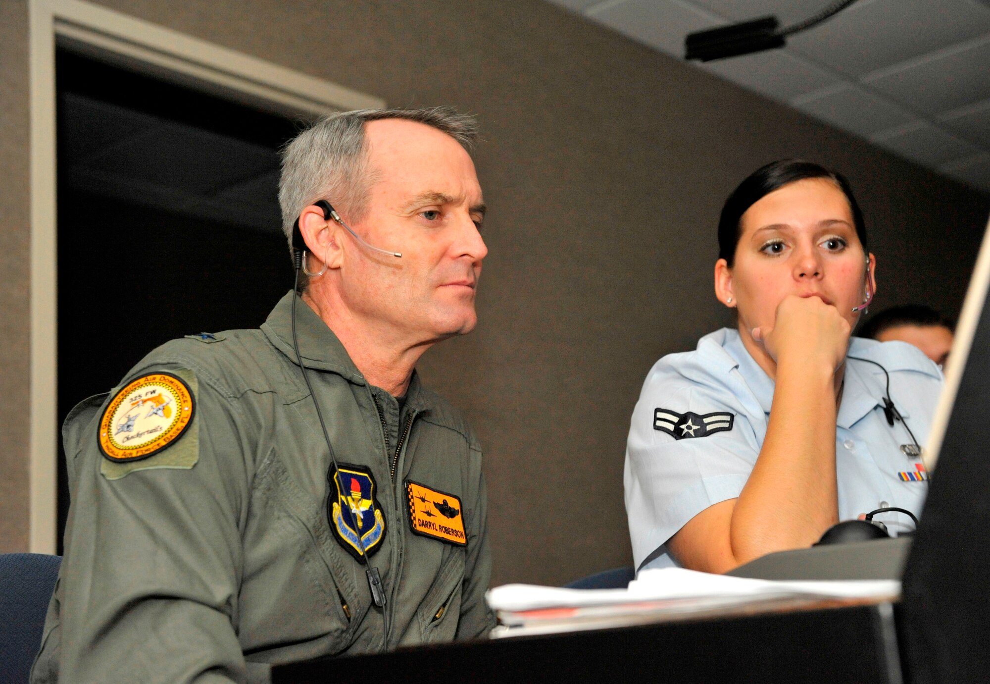Airman 1st Class Ashley Margeson, 325th Operations Support Squadron Air Traffic Controller, controls traffic in the south approach control position while Brig. Gen. Darryl Roberson, 325th Fighter Wing commander, listens in Oct. 5 at the Radar Approach Control.  Airman Margeson, selected for the Commander’s Shadow Program, controls in excess of 127,000 annual operations in more than 4,500 square miles of airspace at 11 different airfields.  She also coordinates aircraft movement with one Air Route Traffic Control Center, five Approach Control and Tower facilities, and three military radar units for the safe and expeditious flow of traffic.   “Ashley bleeds Air Force blue and is truly tops amongst her peers,” said Chief Master Sgt. John Sawyer, Airman Margeson’s supervisor and nominator.  Serving in the Air Force for almost two years, Airman Margeson hails from Waco, Texas.  (U.S. Air Force photo/Jonathan Gibson)