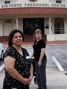 Nelda Rodriguez and Linda Gray both employees at the Air Force Personnel Center (AFPC) stand in front of the center for a photo to kick off observance of National Disability Awawarness month. (U.S. Air Force Photo By/Don Lindsey)