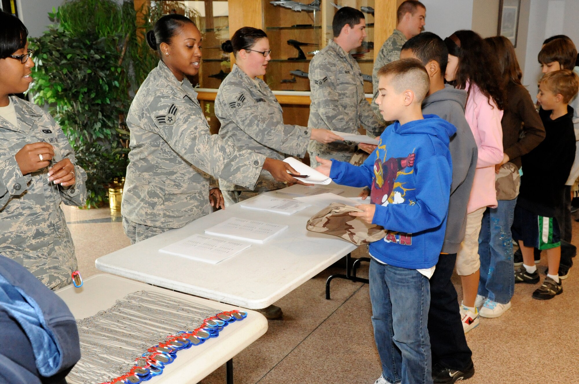Fifth and sixth grade students from McGuire's Upper Elementary School experience a deployment line here Oct 2.  While processing through, the students received a deployment bag, orders, simulated vaccinations, dog tags and a boarding pass. This provided the students with an opportunity to experience first-hand what their parents and friends go through before every deployment.  (U.S. Air Force photo/Wayne Russell)
