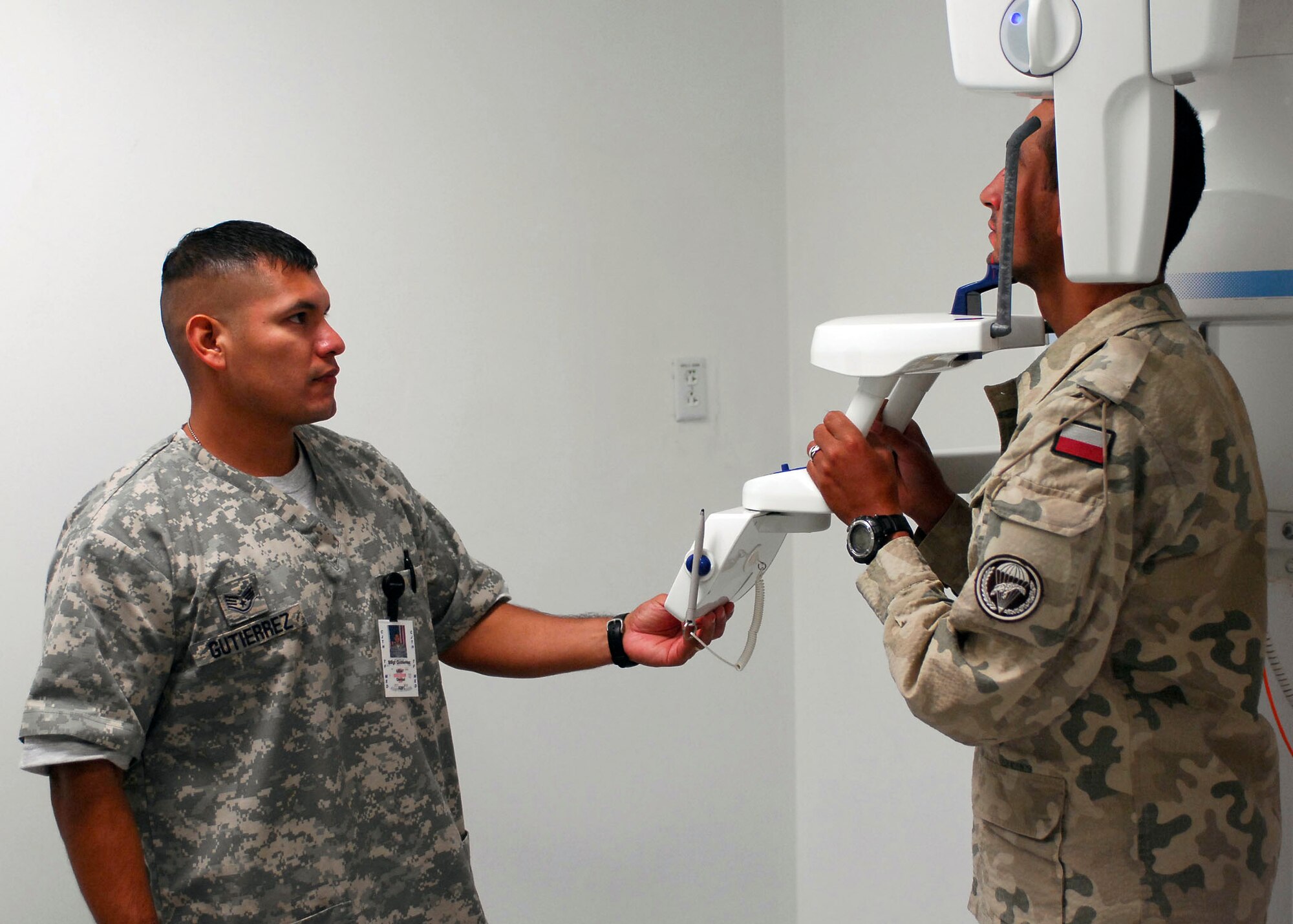 Staff Sgt. Juan Gutierrez positions a patient for a panoramic X-ray Sept. 26, 2009, at Bagram Airfield, Afghanistan. Sergeant Gutierrez is deployed to Afghanistan for six months, currently serving as the dental clinic NCO in charge for Task Force Medical. (U.S. Air Force photo/Senior Airman Felicia Juenke) 