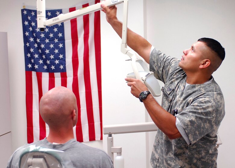 Staff Sgt. Juan Gutierrez sets up for a patient Sept. 26, 2009, at Bagram Airfield, Afghanistan. Sergeant Gutierrez is deployed from Randolph Air Force Base, Texas, to Afghanistan for six months, currently serving as the dental clinic NCO in charge for Task Force Medical.  (U.S. Air Force photo/Senior Airman Felicia Juenke) 