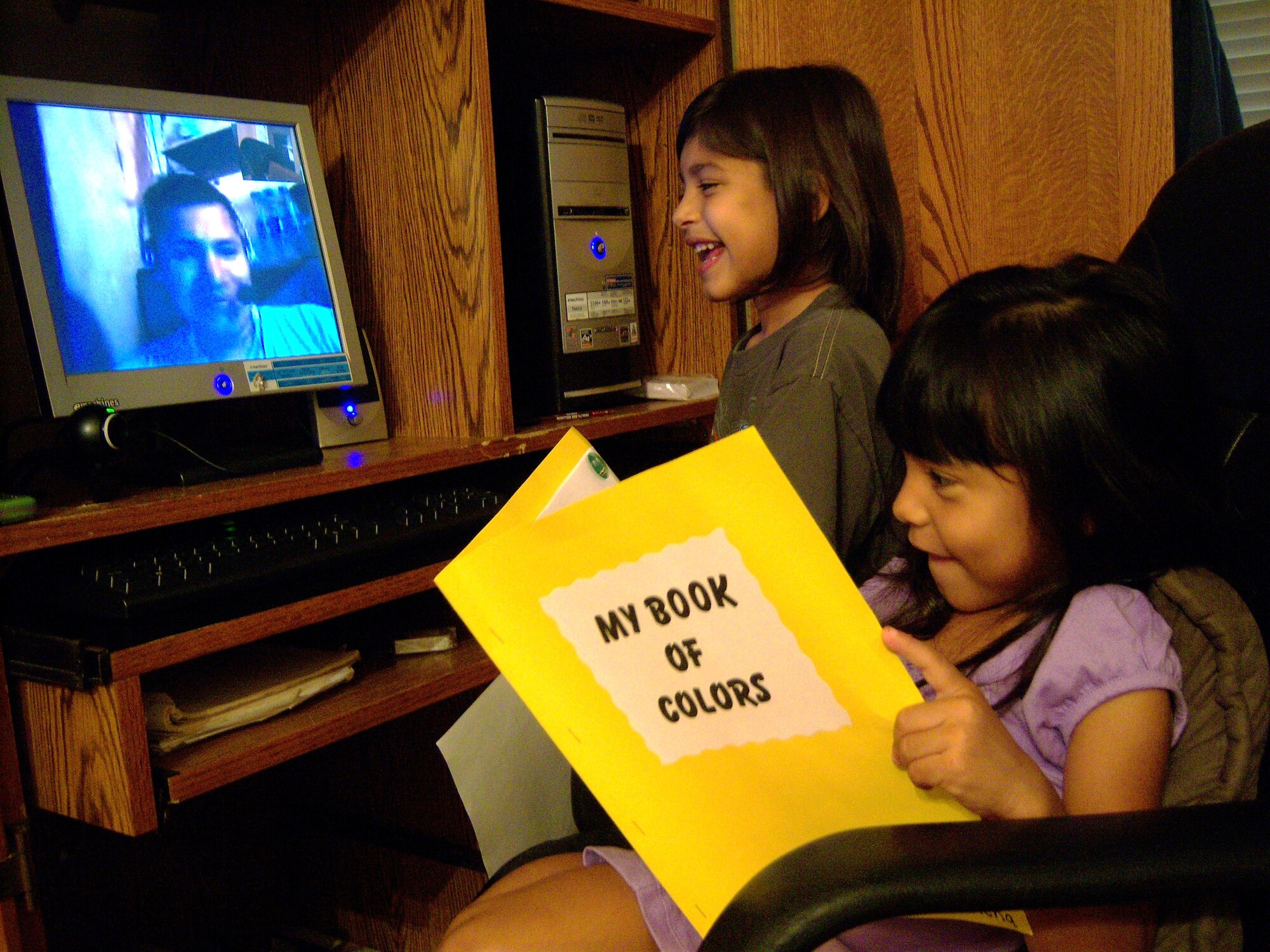 J.J. (standing) and Elena Gutierrez talk to their father over the Internet Sept. 26, 2009, from Randolph Air Force Base, Texas, while he's deployed to Bagram Airfield, Afghanistan. Staff Sgt. Juan Gutierrez, assigned to the 12th Dental Squadron, and his family use computers, Web cams and microphones to see and hear each other almost daily during his six-month deployment. (U.S. Air Force photo/Tech. Sgt. Sonny Cohrs) 