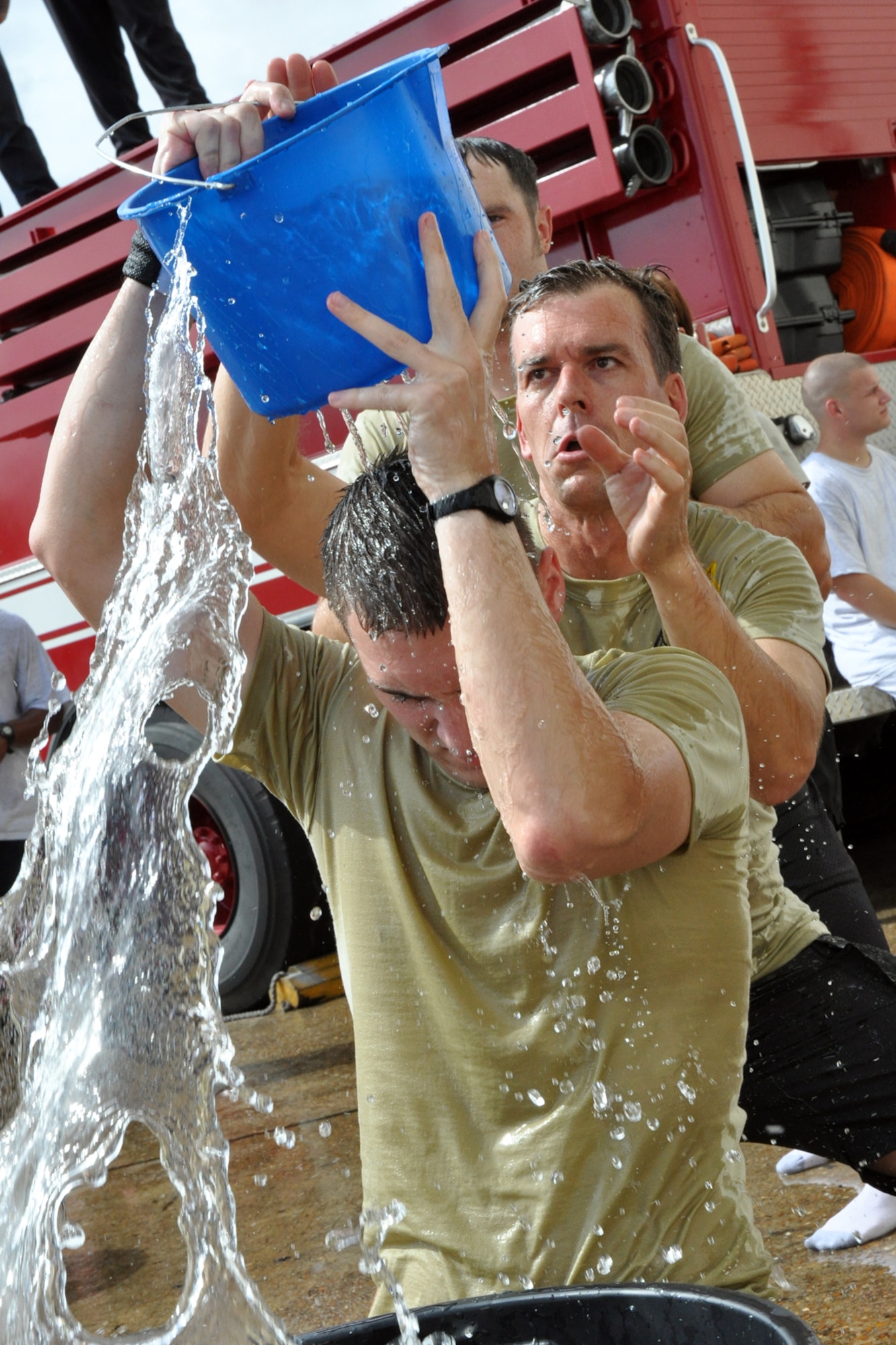 EGLIN AIR FORCE BASE, Fla. – 1st Lt.  Jonathan Heckinger, 96th Air Base Wing staff, passes a bucket of water to Col. Bruce McClintock, 96th ABW commander, while competing in a bucket brigade challenge during the Fire Muster Challenge, Oct, 5. The event gave Airmen a chance to have fun while gaining an appreciation for the firefighter experiences. The Commanders vs. First Sergeants Challenge and the Commander’s Challenge, hosted the same day, kicked off Fire Prevention Week. (U.S. Air Force photo/ Airman Anthony Jennings)