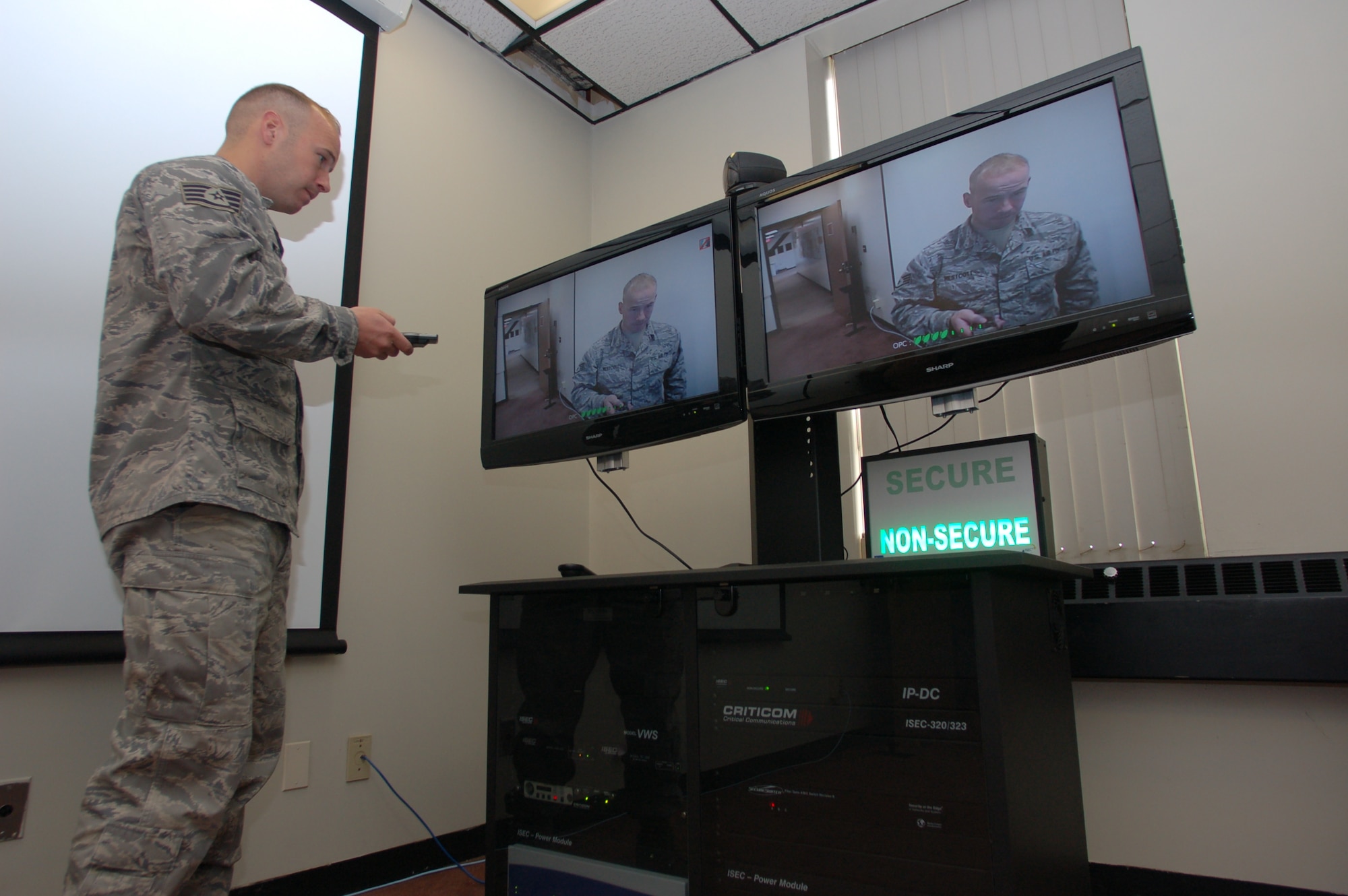 Staff Sgt. Paul Westcott, knowledge management operations apprentice, 103rd Air and Space Operations Group, configures the newly acquired video teleconferencing equipment suite during a routine operational check, October 1, 2009.  The new VTC capability will enable members of the Connecticut Air National Guard to communicate directly with supported units across the globe.  (U.S. Air Force photo by Capt Bryon M. Turner)
