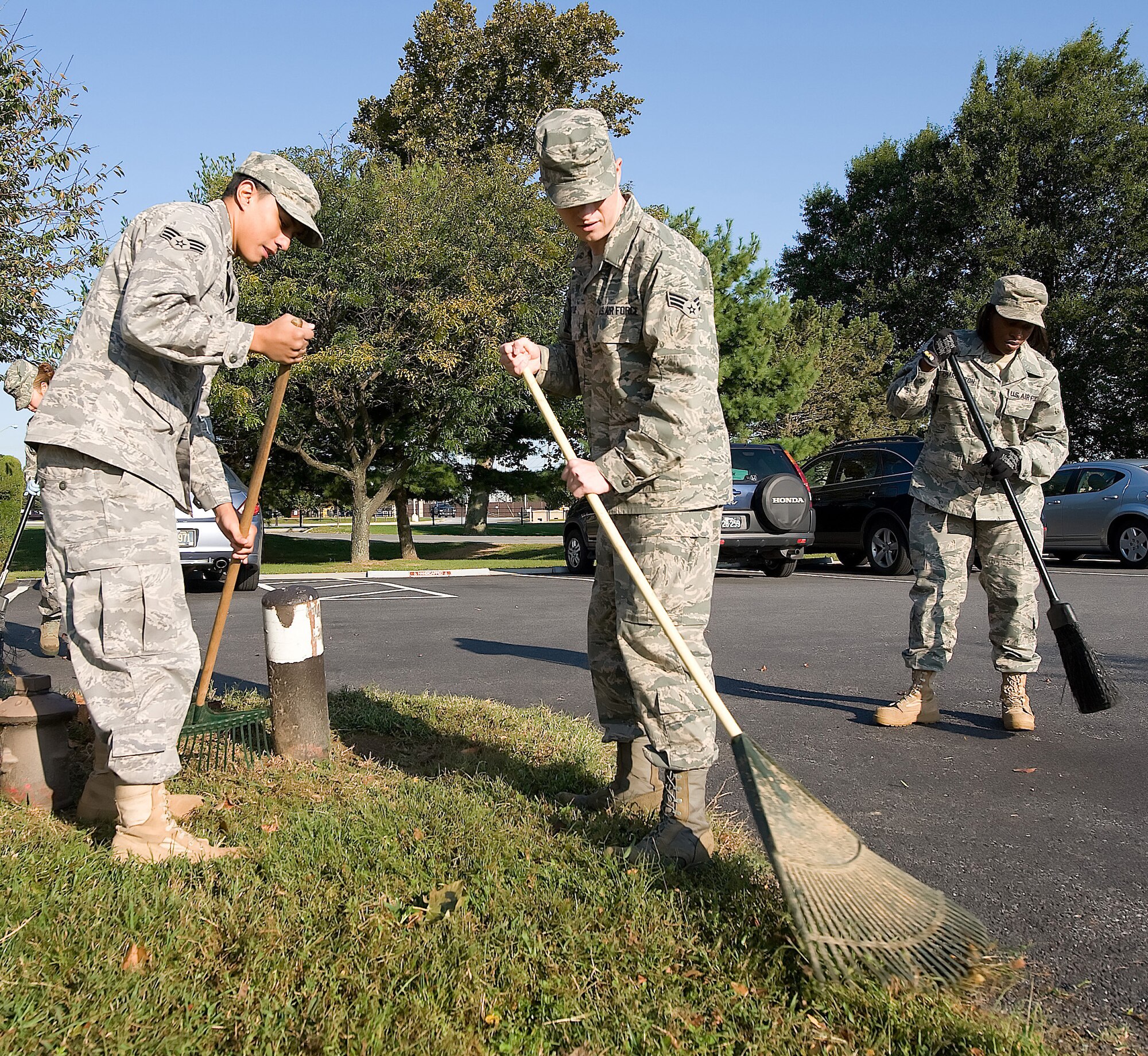 Team Dover members participate in a base clean up Oct. 1 in preparation for the annual Military Construction Breakfast.  Each year, the wing commander briefs Delaware?s congressional delegation and community leaders about ongoing and future construction at Dover Air Force Base.  (U.S. Air Force photo/Jason Minto)