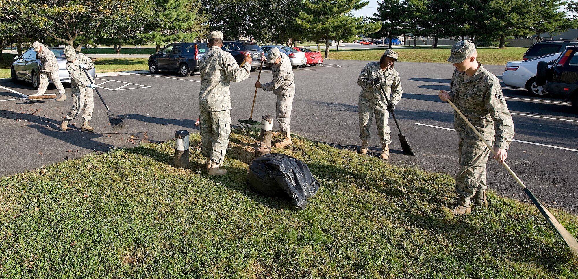 Team Dover members participate in a base clean up Oct. 1 in preparation for the annual Military Construction Breakfast.  Each year, the wing commander briefs Delaware?s congressional delegation and community leaders about ongoing and future construction at Dover Air Force Base.  (U.S. Air Force photo/Jason Minto)