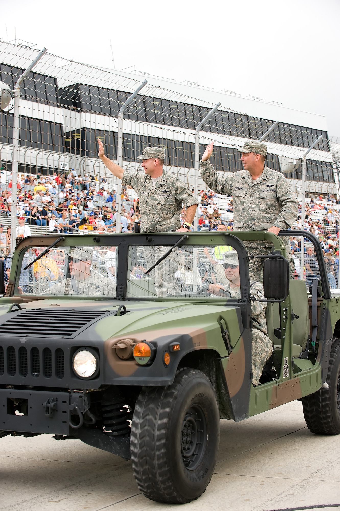 Col. Manson Morris, 436th Airlift Wing commander, and Col. Michael Fitzhenry, 512th AW commander, wave to the crowd during the parade lap before the start of the AAA 400 NASCAR Race at Dover International Speedway Sept. 27.  (U.S. Air Force photo/Jason Minto)