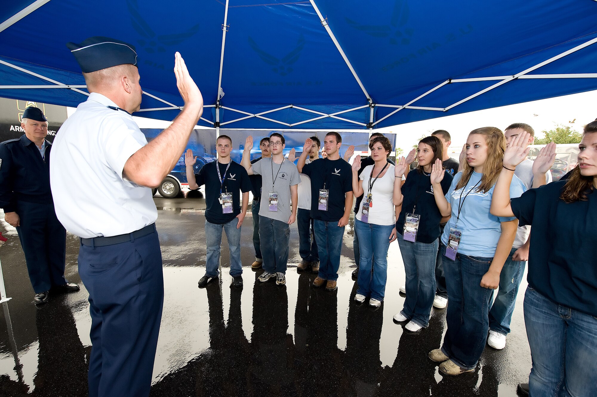 Major General Mark S. Solo, 618th Tanker Airlift Control Center commander, swears in new Air Force recruits before the start of the NASCAR AAA 400 Race at the Air Force Recruiter's booth at Dover International Speedway.  (U.S. Air Force photo/Jason Minto)
