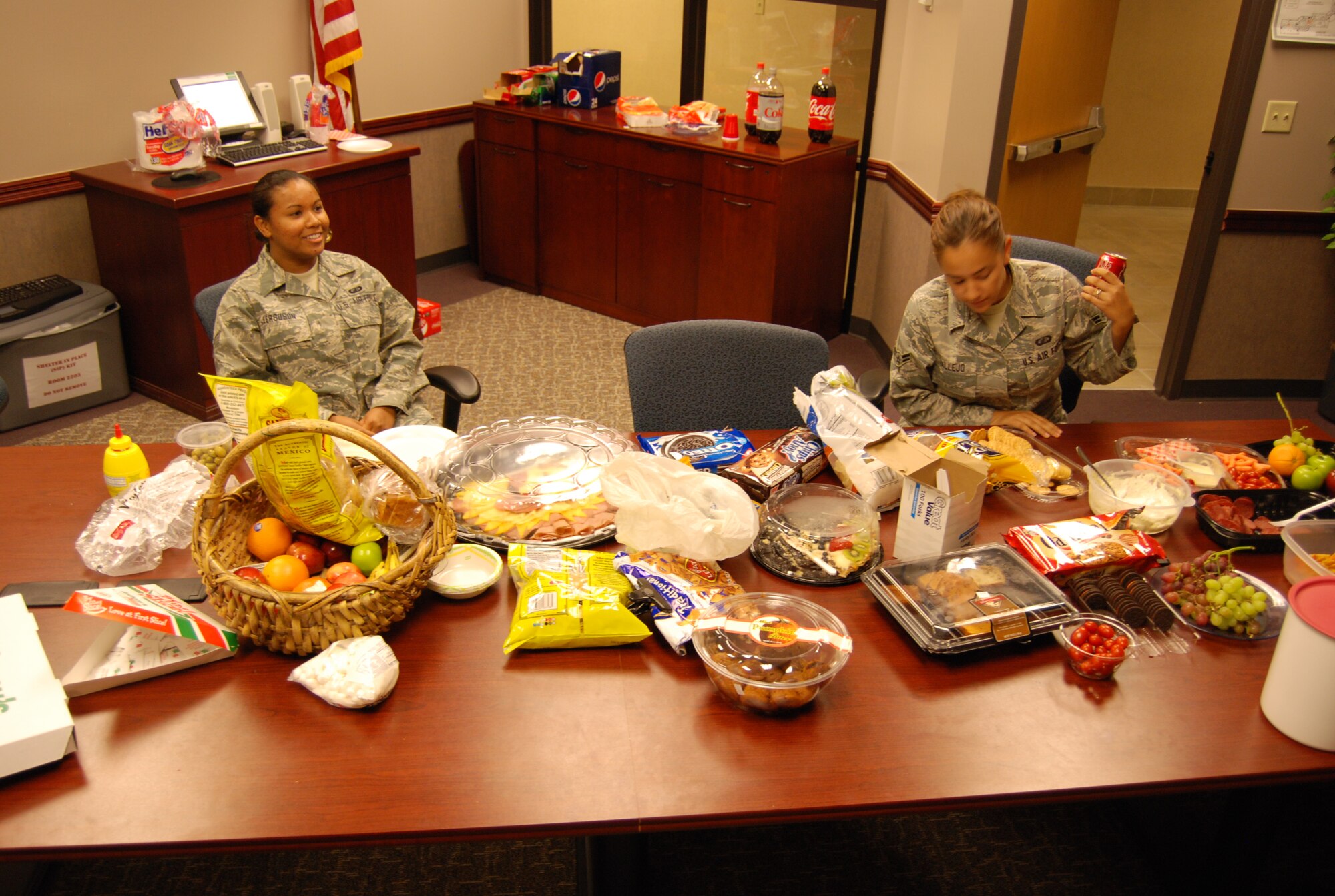 PETERSON AIR FORCE BASE, Colo. -- Senior Airman Grace Ferguson, 21st Comptroller Squadron budget analyst, and Airman 1st Class Aarial Vallejo, 21st CPTS financial liaison, take a break from the hectic pace of end of year purchasing Sept. 30. Airmen and civilians worked into the night – some until 3 a.m. Oct. 1 – to capitalize on end of year funding for the wing. Their efforts translated into more than $9 million in additional funding for the wing. (U.S Air Force photo by Steve Brady)