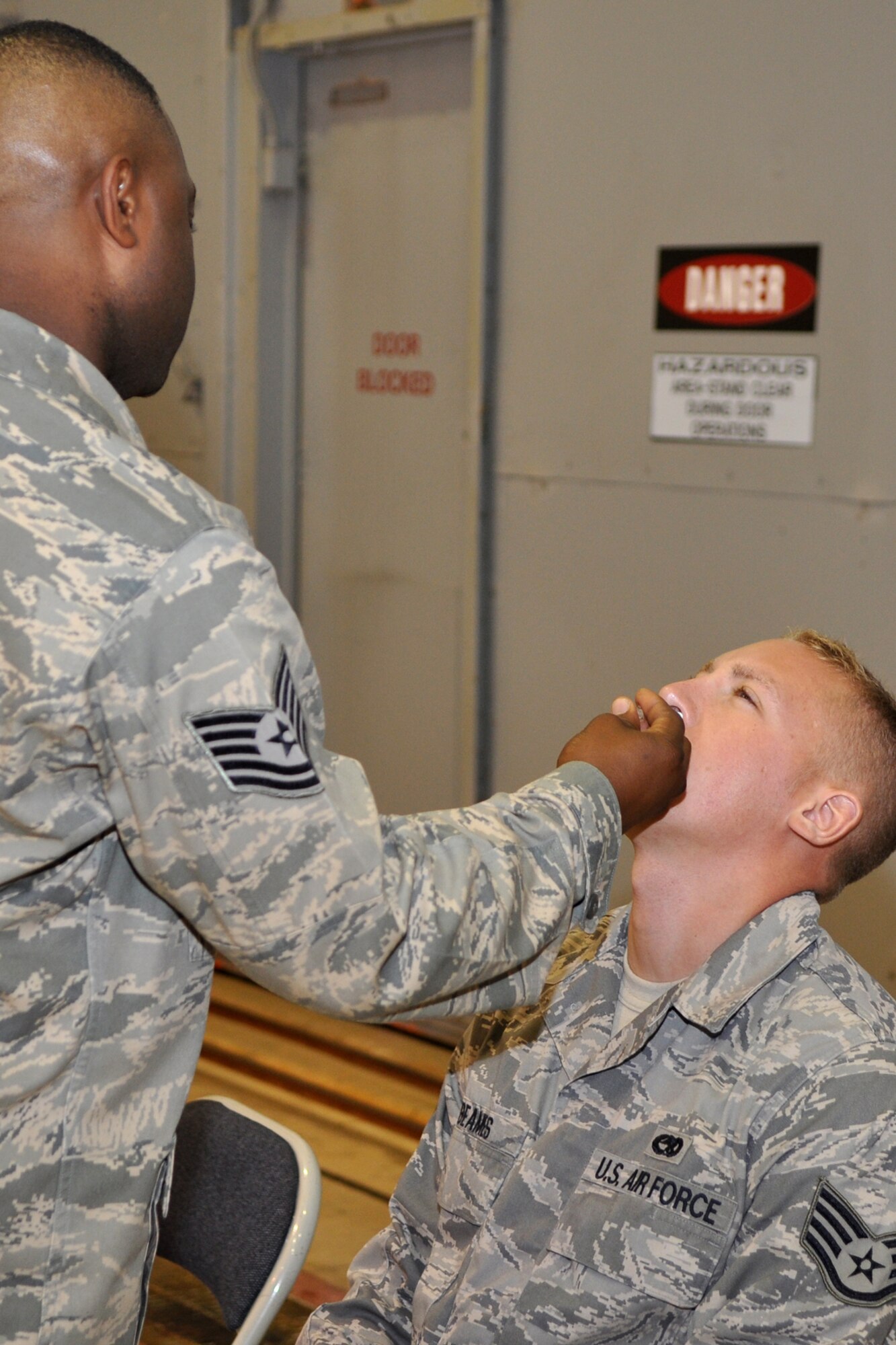 Staff Sgt. Bradley Beams, 917th Aircraft Maintenance Squadron, B-52 aircraft mechanic, receives the mist injection of the flu vaccine from Technical Sgt. Akerele Adeyemi, 917th Medical Squadron, medical services attendant, in the A-10 Hangar at Barksdale Air Base, La., October 4, 2009. Unlike the “flu shot,” which is an inactivated (killed) vaccine injected into the muscle, the flu mist, is a live, attenuated (weakened) influenza vaccine sprayed into the nostrils. Influenza viruses are always changing. Because of this, influenza vaccines are updated every year, and an annual vaccination is recommended, but is mandatory for the military. These “seasonal” influenza vaccines are formulated to prevent annual flu, and do not protect against pandemic H1N1 influenza. It takes up to two weeks for protection to develop after the shot, and protection lasts up to a year. (U.S. Air Force photo/Tech. Sgt. Jeff Walston) 