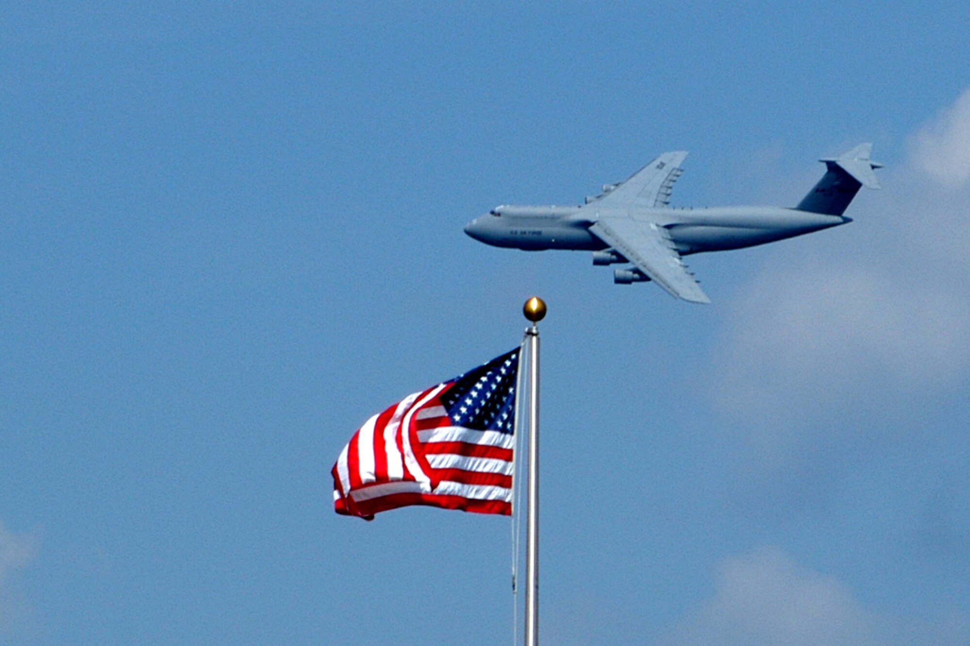 GRISSOM AIR RESERVE BASE, Ind., -- A giant C-5 Galaxy cargo aircraft assigned to the 445th Air Lift Wing, Wright-Patterson AFB, Ohio, passes over Grissom recently.  The airlifter's crews were "shooting approaches" for training where they practice lining the aircraft up for different types of landings.  Grissom?s Midwest location away from major cities and population areas makes it ideal for aircraft from bases all over the eastern United States to practice ?approach? procedures for training.  The C-5 is one of the largest aircraft in the world and the largest airlifter in the Air Force inventory. The C-5 can carry more cargo than any other airlifter.  Although C-5 aircraft are almost 40 years old they continue to play a key role in strategic airlift for the nation.    (Air Force photo/Staff Sgt. Chris Bolen)