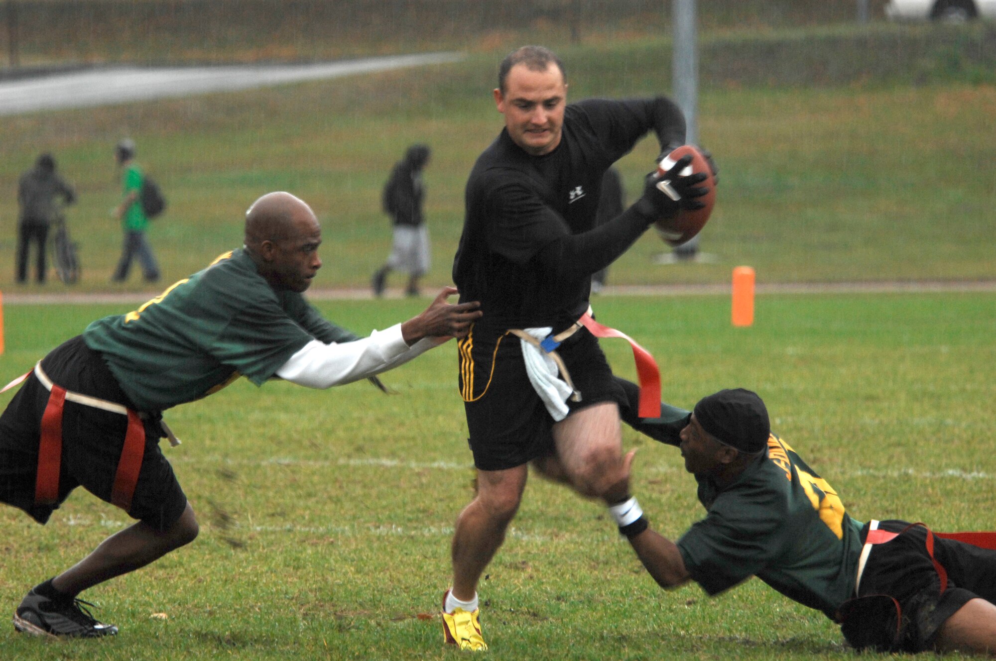 Randy McGinnis, Team Comm quarterback, breaks through defenders while running the ball back for a touchdown during a flag football playoff game against the 86th Dental Squadron, Oct. 5, 2009, Vogelweh Military Complex, Germany.  The 86th Communications Squadron triumphed over the 86th Dental Squadron 26-6 in the first game of the playoffs.  (U.S. Air Force photo by Tech. Sgt. Chenzira Mallory)