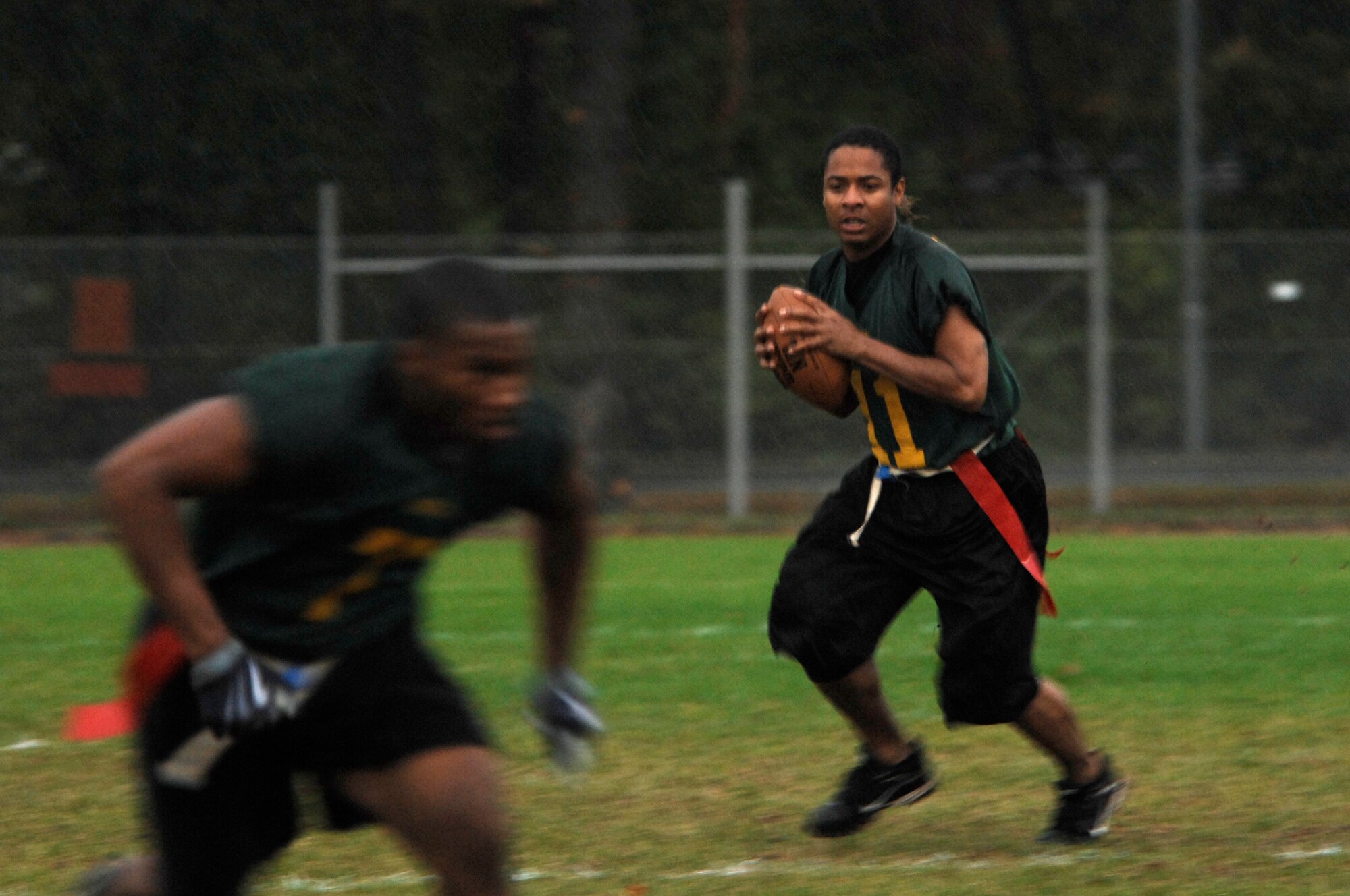 Wunsa Cleveland (right), 86th Dental Squadron team quarterback, looks down field for an open receiver during a flag football playoff game against the 86th Communications Squadron, Oct. 5, 2009, Vogelweh Military Complex, Germany.  The 86th Communications Squadron triumphed over the 86th Dental Squadron 26-6 in the first game of the playoffs.  (U.S. Air Force photo by Tech. Sgt. Chenzira Mallory)