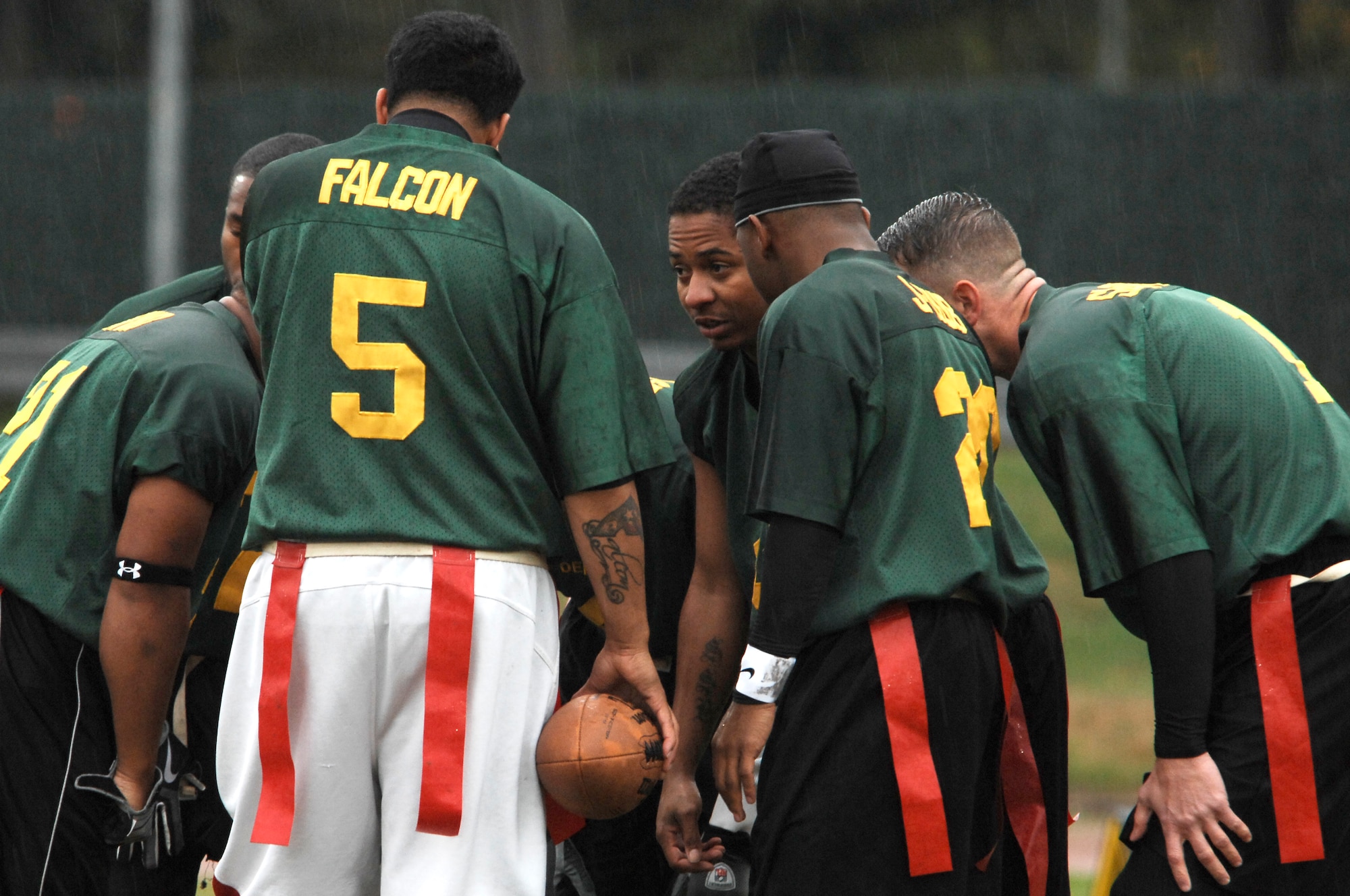 In between downs, the 86th Dental Squadron huddles up while Wunsa Cleveland, team quarterback, relays the next play, during the flag football playoff game against the 86th Communications Squadron, Oct. 5, 2009, Vogelweh Military Complex, Germany. The 86th Communications Squadron triumphed over the 86th Dental Squadron 26-6 in the first game of the playoffs.  (U.S. Air Force photo by Tech. Sgt. Chenzira Mallory)