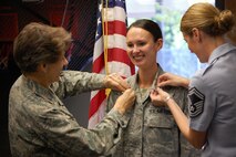 SEYMOUR JOHNSON AIR FORCE BASE, N.C. -- Reservist Kim Lewis (center) is promoted to the rank of major on Sept. 28, 2009. Col. Caroline Evernham, 916th Operations Group commander and Senior Master Sgt. Dana Bates, 916th Aircrew Flight Equipment superintendent did the honors. 